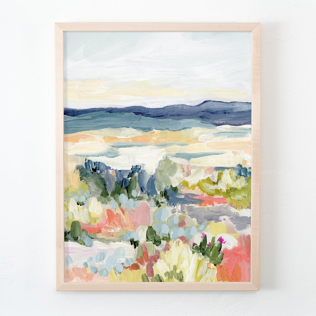 Desert dawn landscape painting in a frame.
