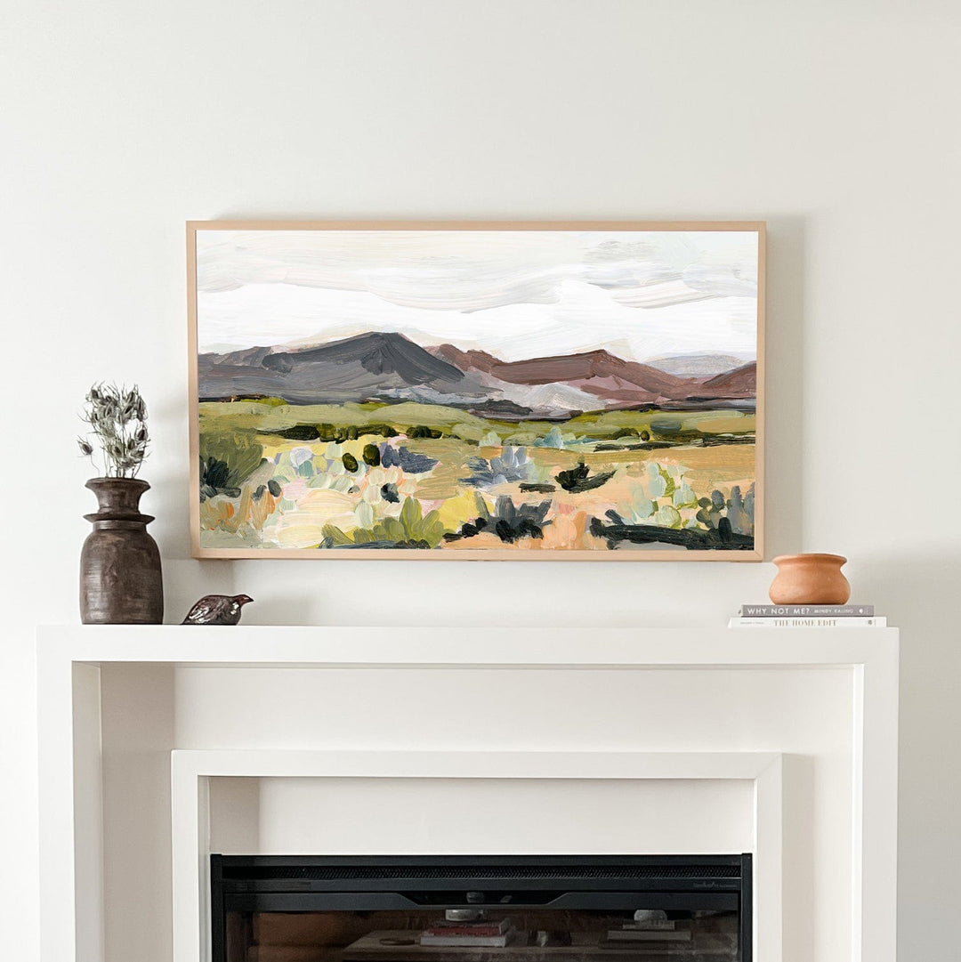 Mauve fireplace setup with landscape painting.