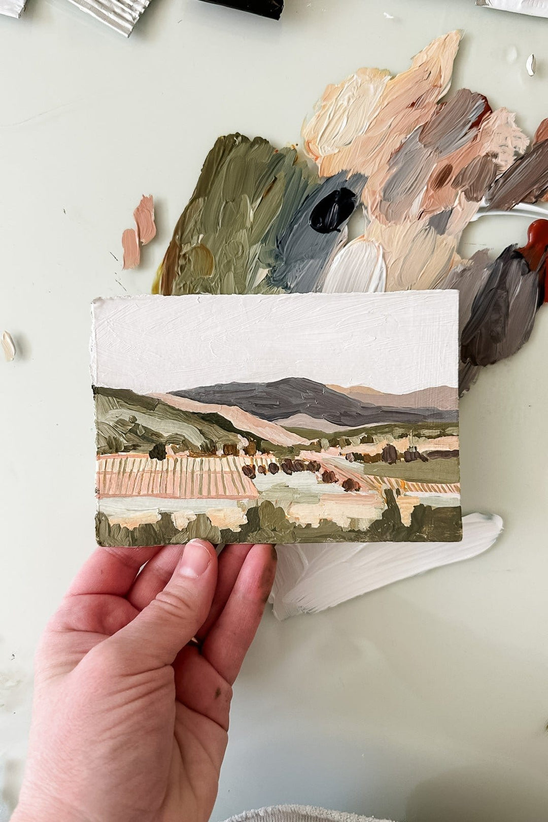 Napa Valley landscape painting held in hand
