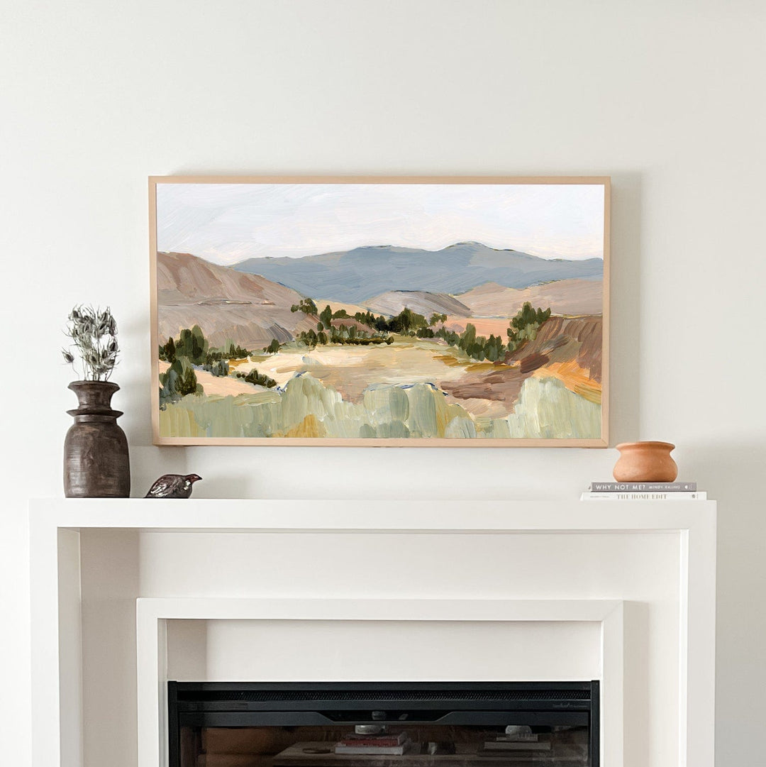 Oregon hills landscape painting framed above fireplace