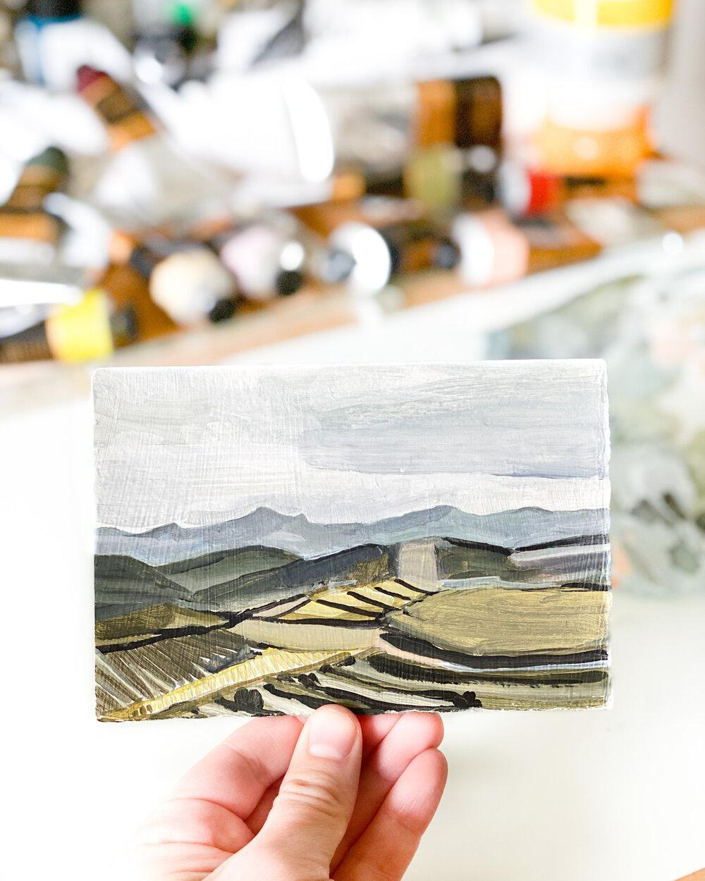 Hand holding landscape painting, 0962675B-4843
