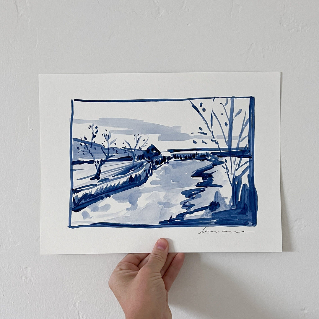 Ink painting of a landscape held in a hand.