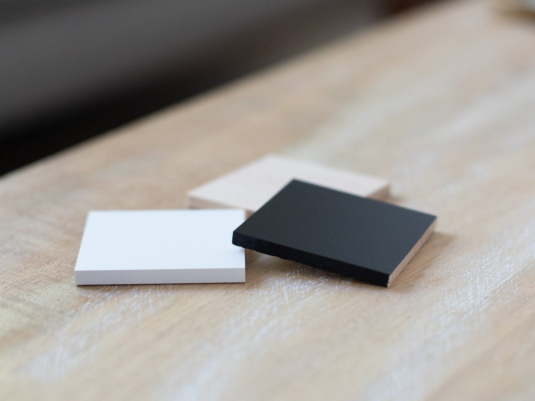 white, beige, and black, on a wooden surface.