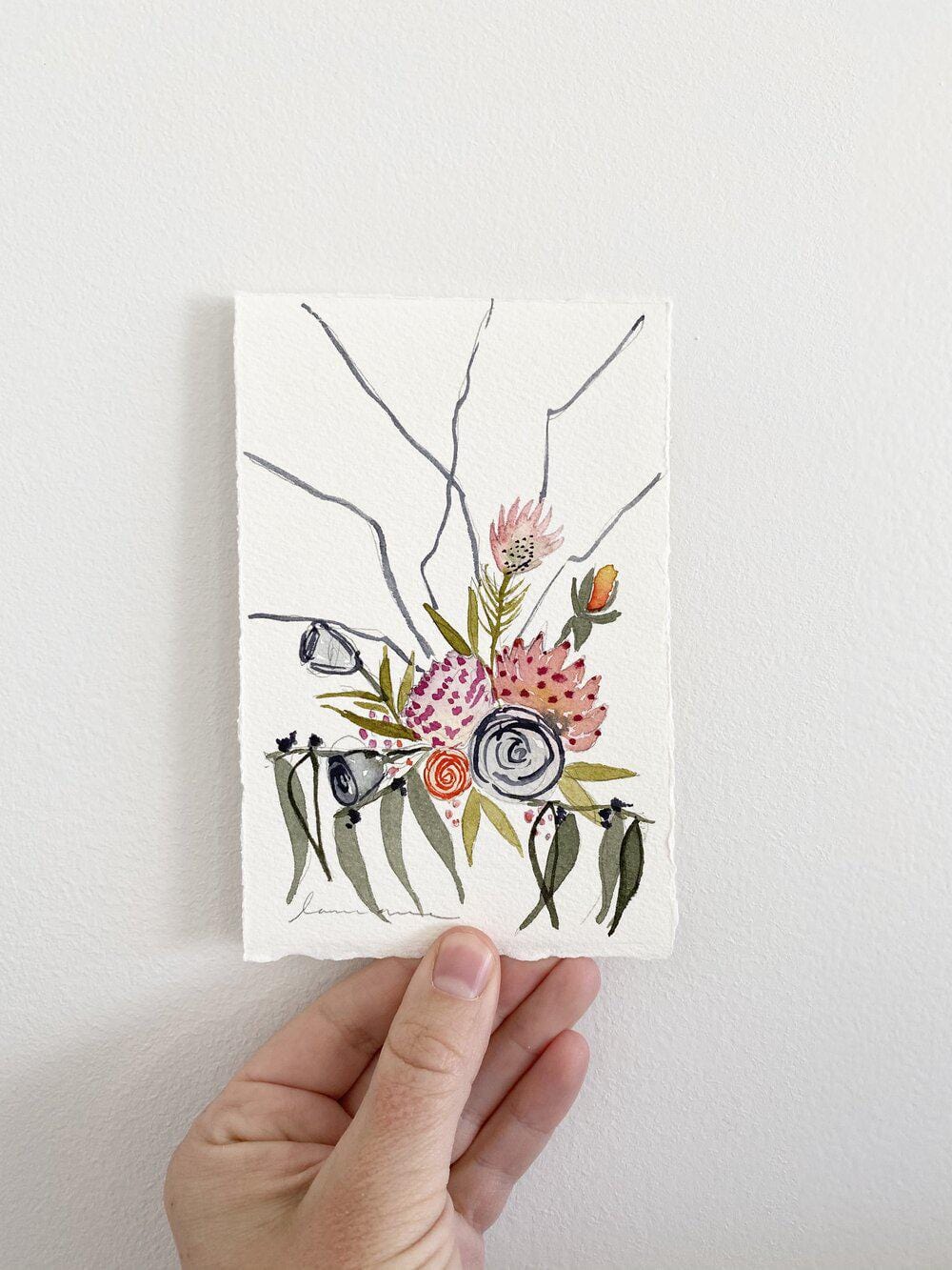 Watercolor floral art print held in hand
