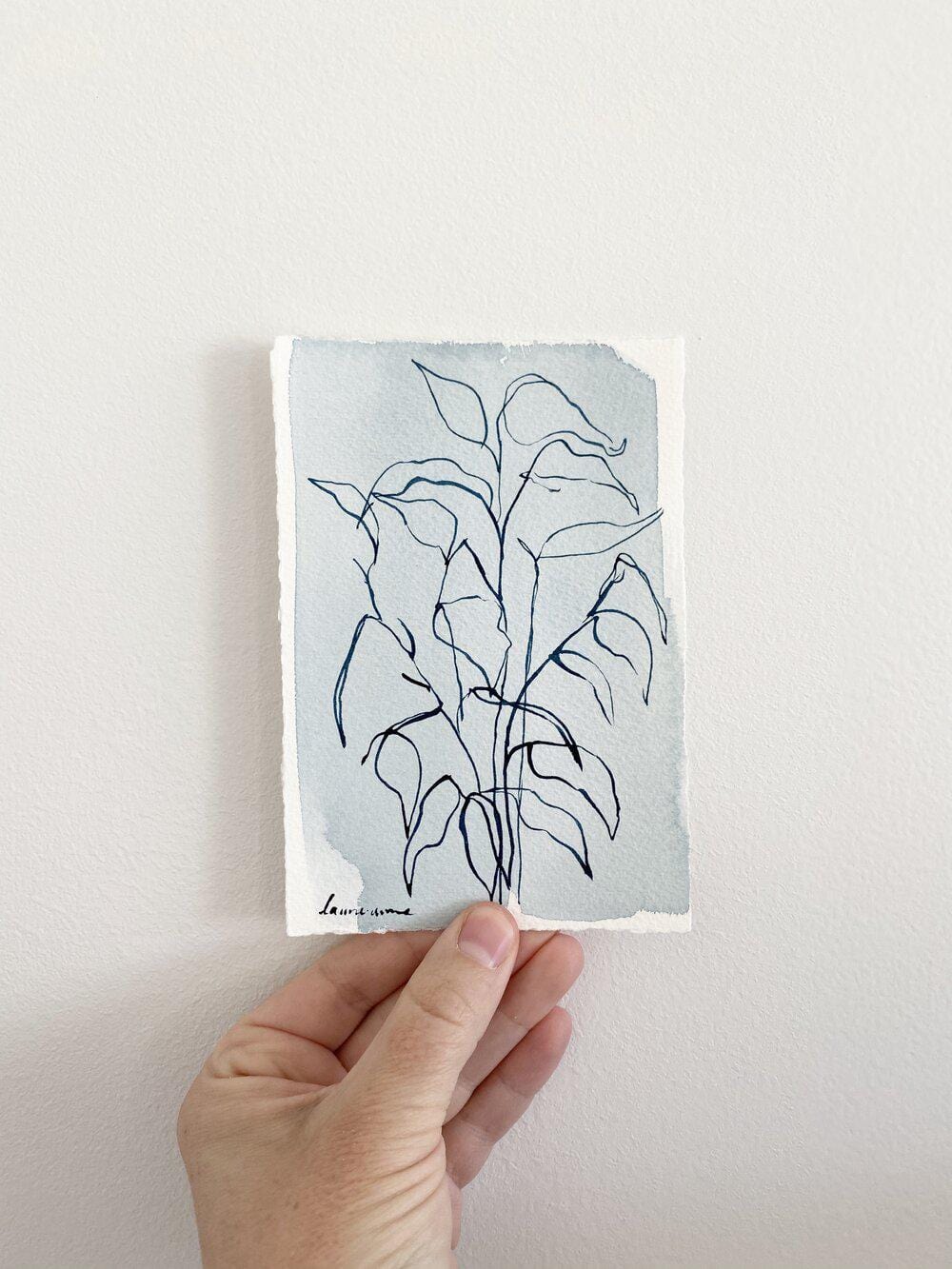 Hand holding botanical line art painting
