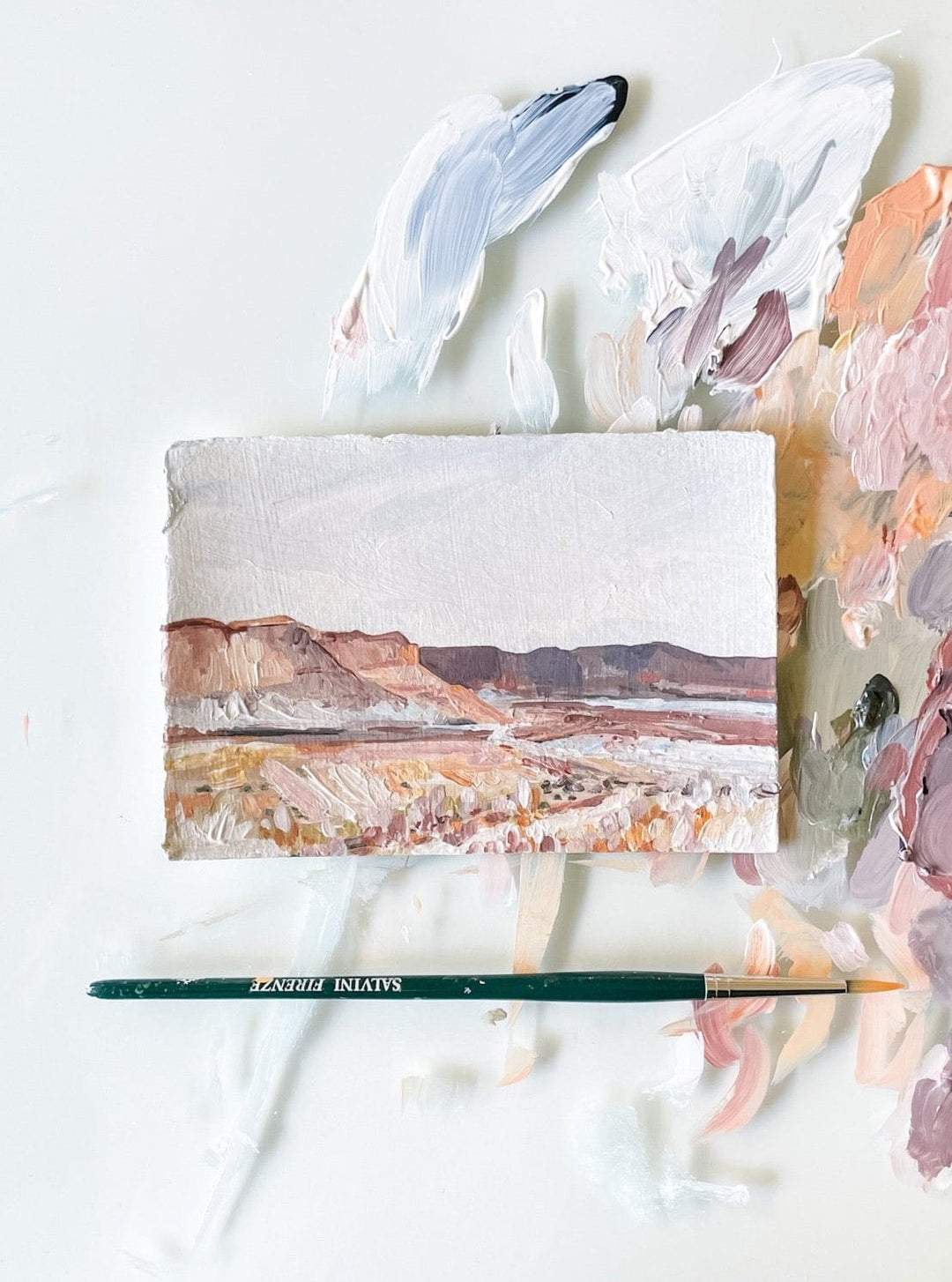 Landscape painting with brush and paint palette.