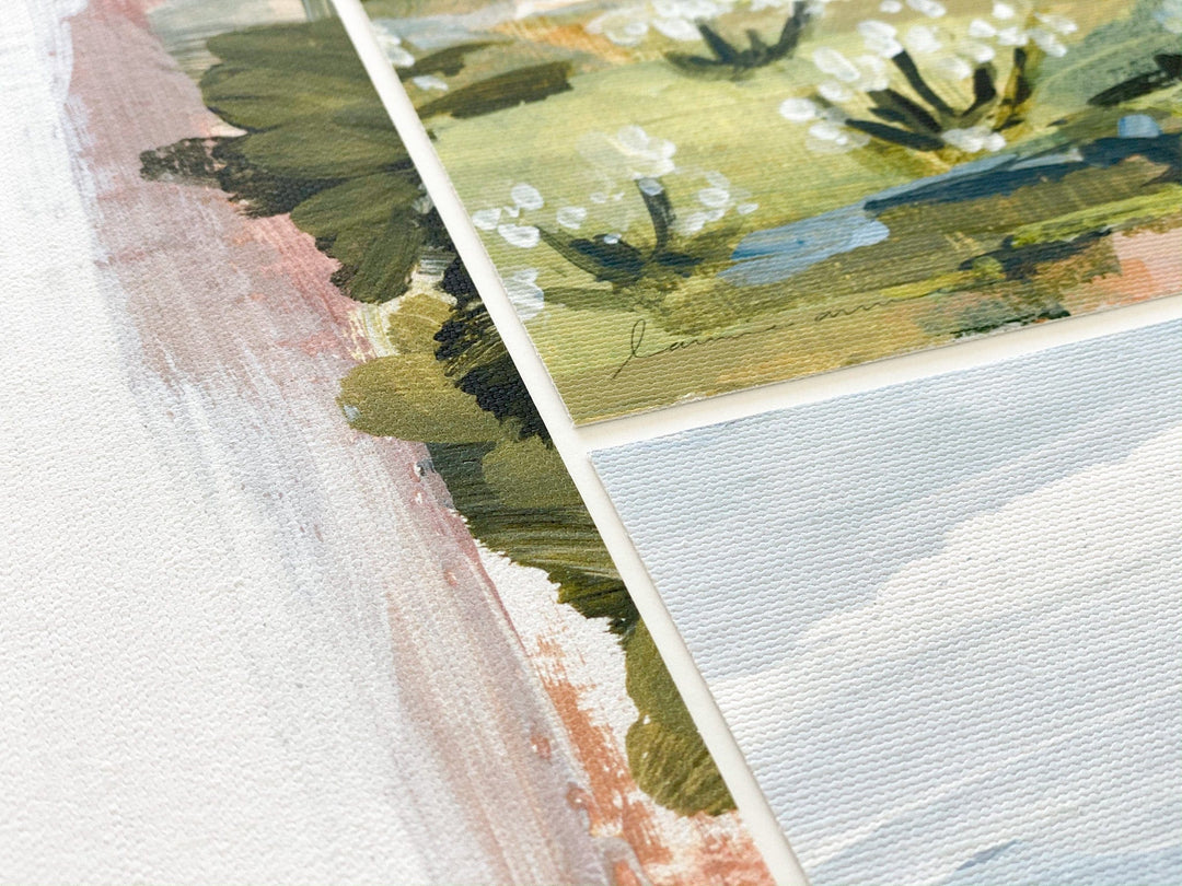 Close-up of three abstract landscape paintings.