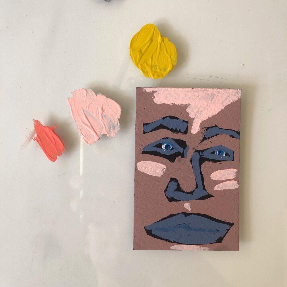 Abstract painting of a face with paint swatches.