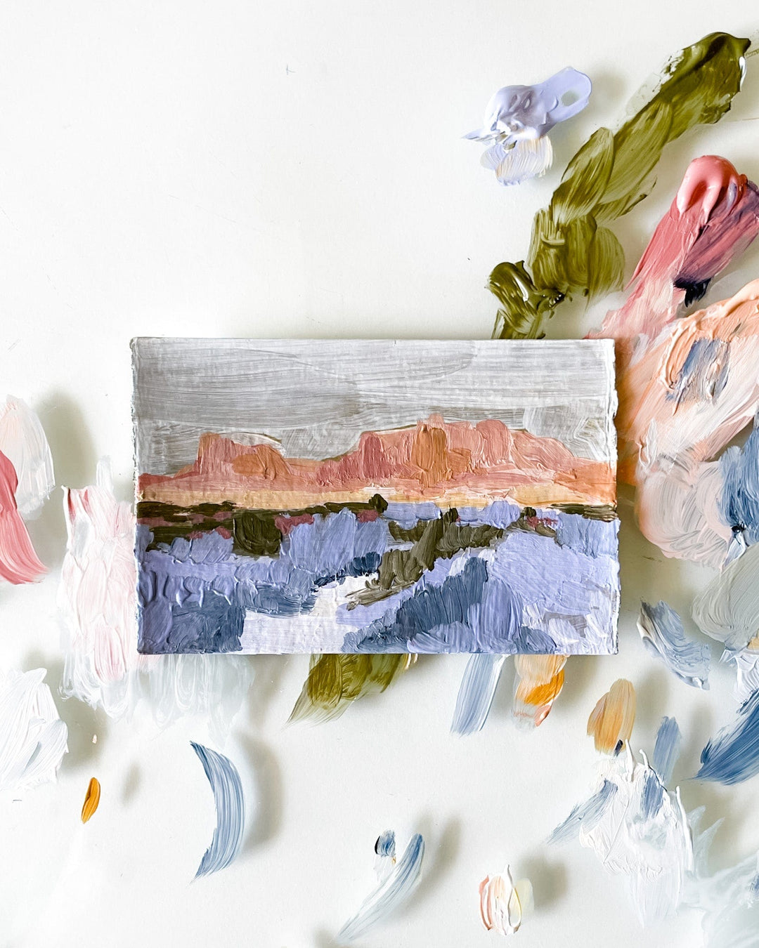 Painting of a landscape with colorful paint palette.