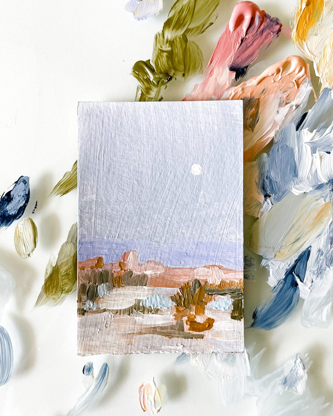Miniature landscape painting with paint palette.