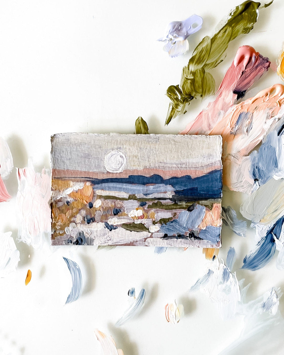 Small landscape painting with paint swatches.