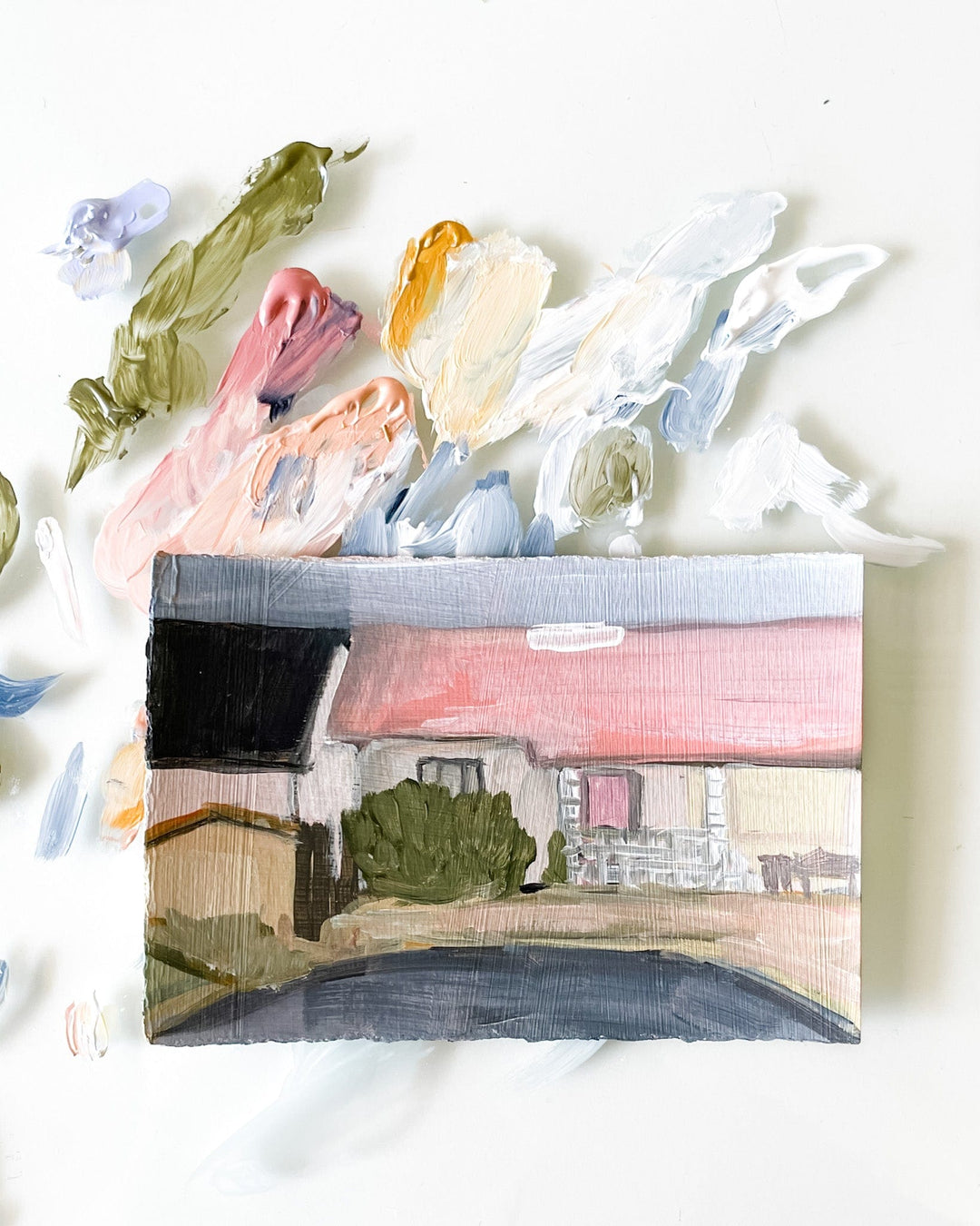 Painting of a house with paint swatches.