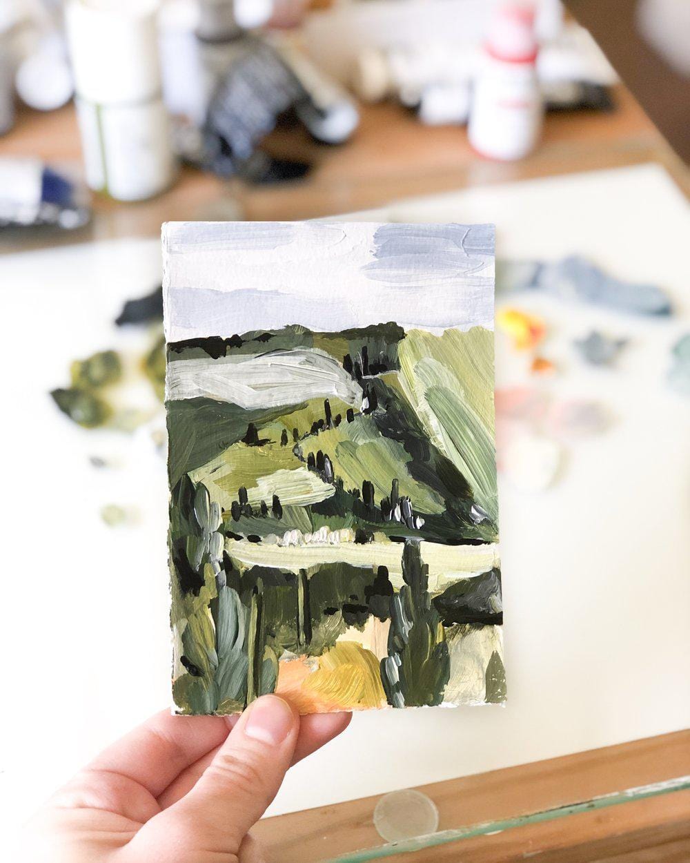 Hand holding landscape painting IMG_8383.