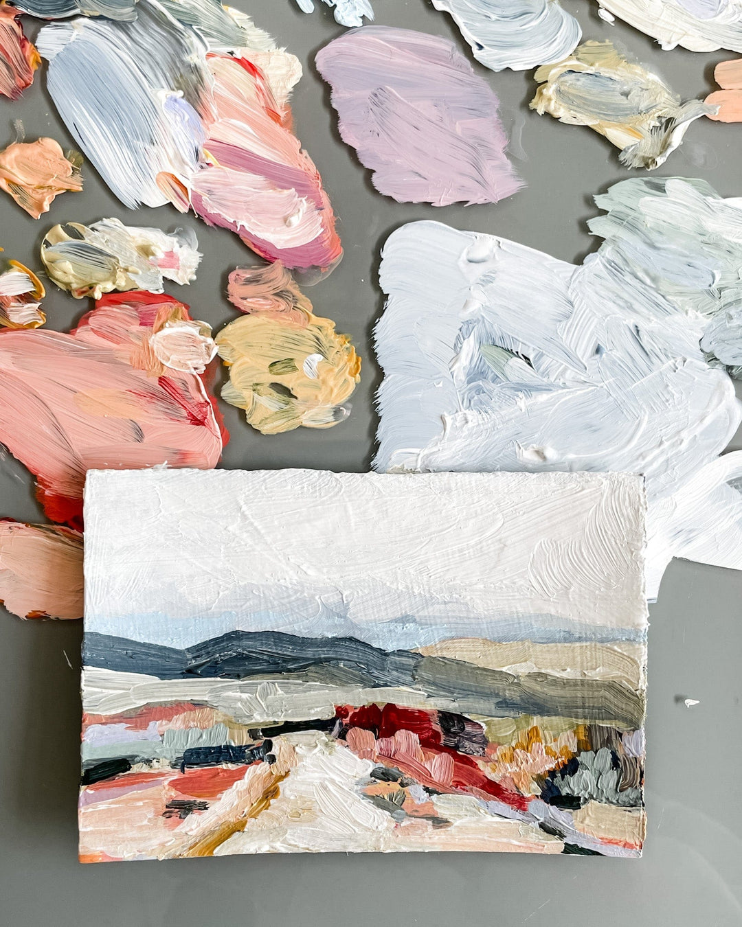 Painting of a landscape with paint palette.
