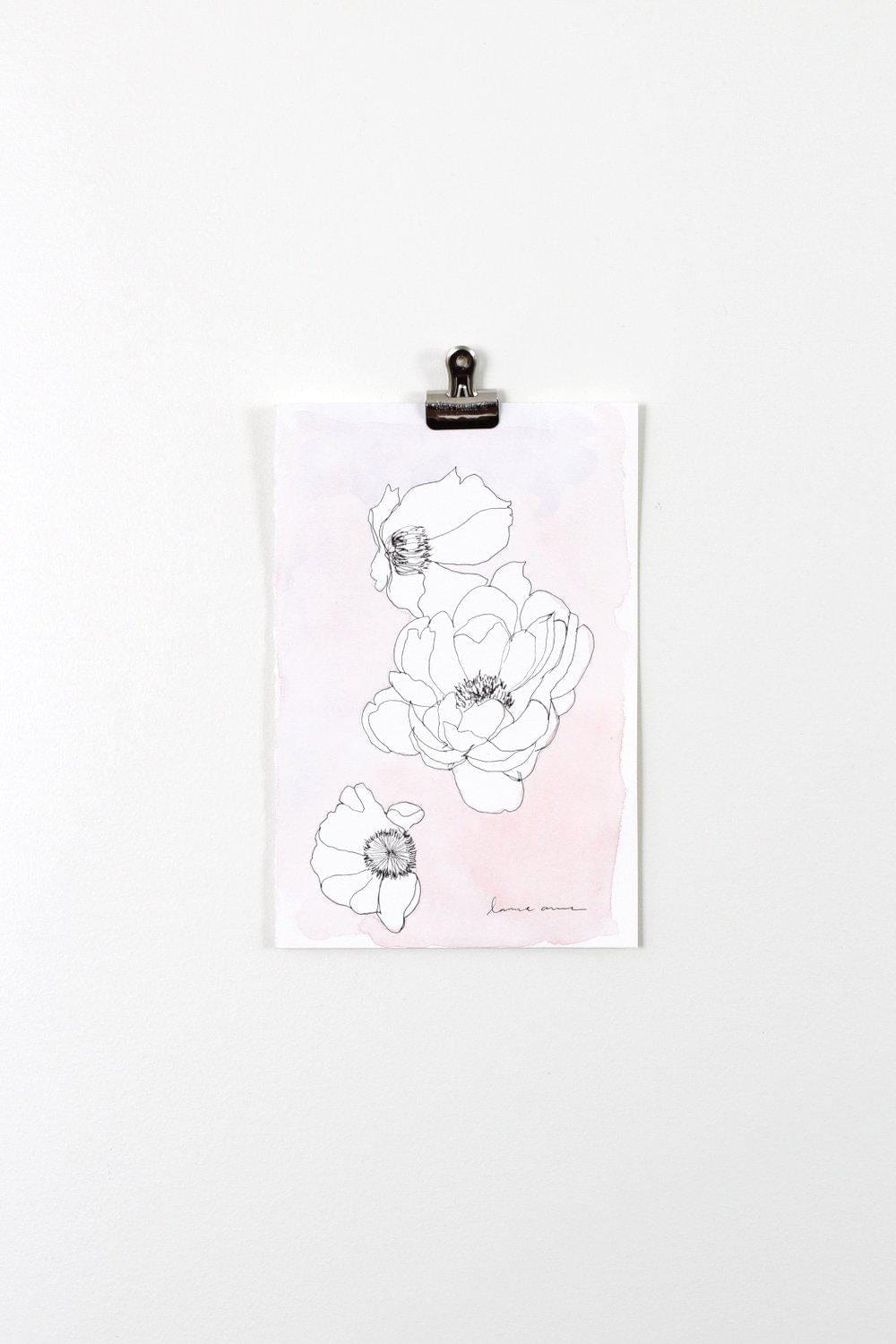 Floral line art print on white wall.