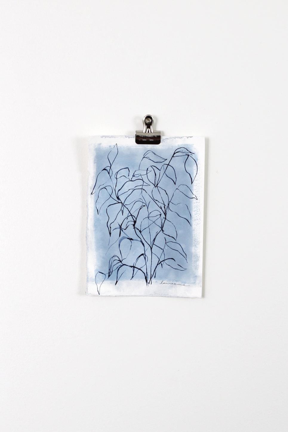 Blue leaves art print on white wall