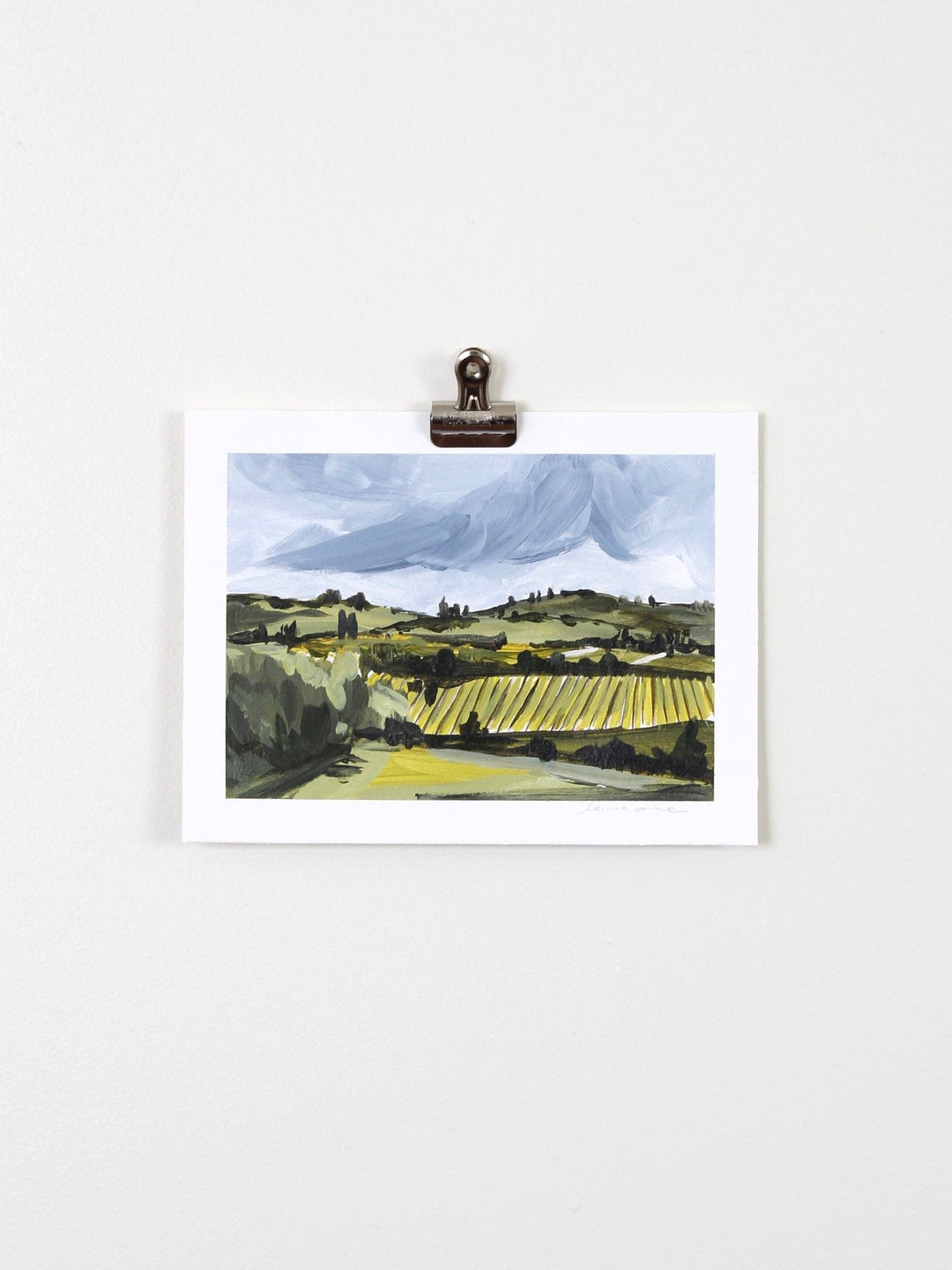 Landscape painting print clipped to wall