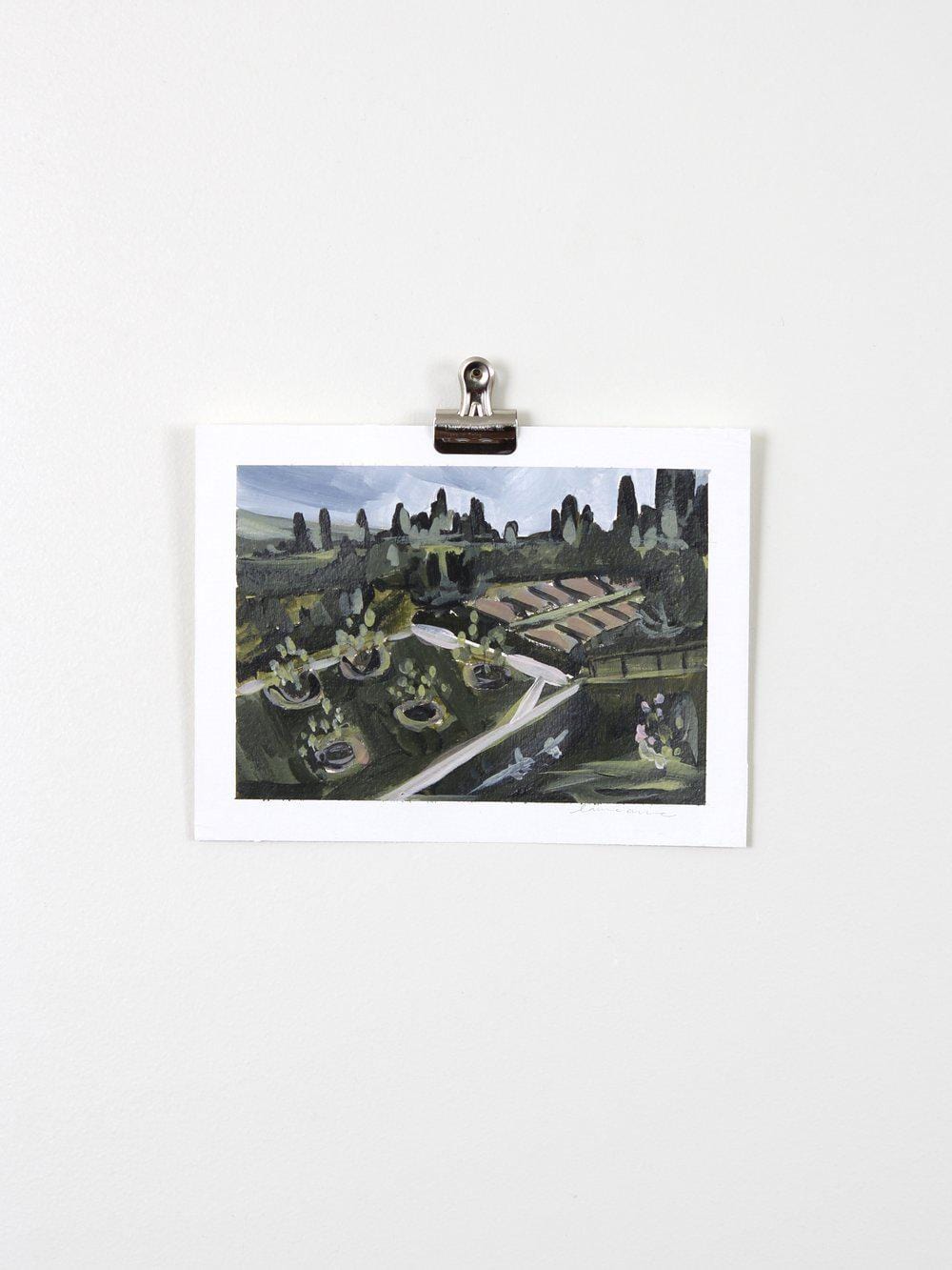 Painting of a garden scene clipped to a wall.