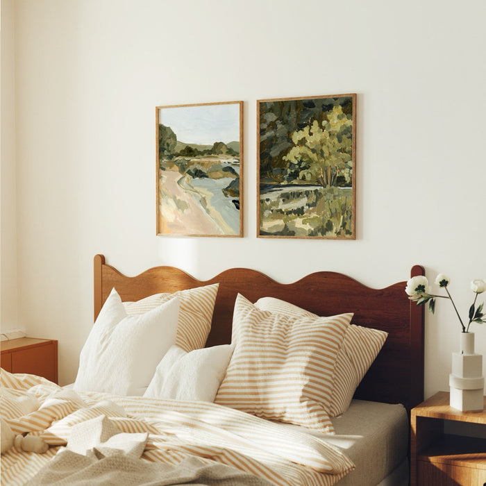 2 art prints hanging over a bed