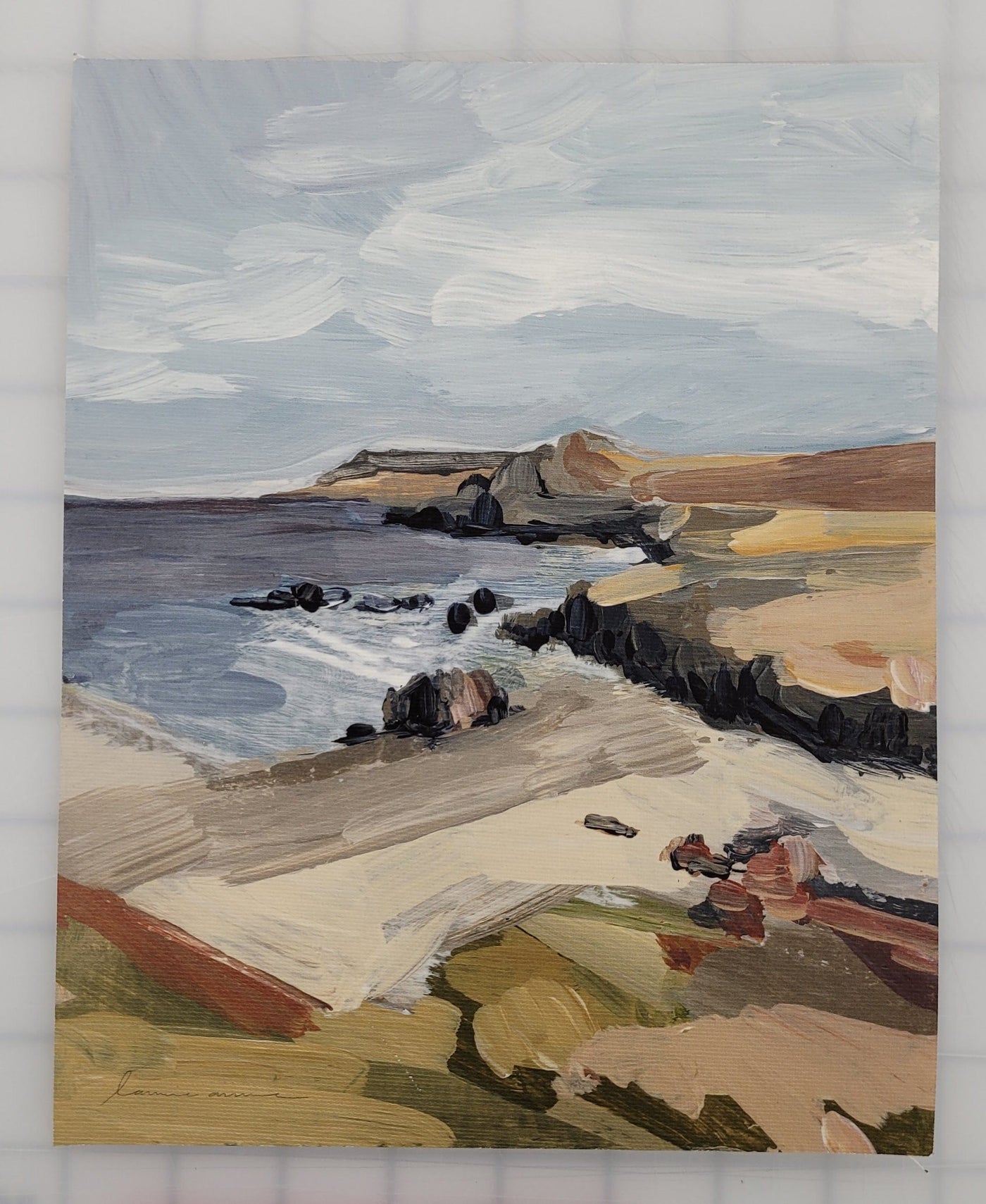 Coastal landscape painting with beach, ocean, and cliffs.